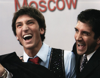 Evan Lysacek of the United States and his coach Ken Congemi react after winning bronze medal at the World Figure Skating Championships in Moscow.